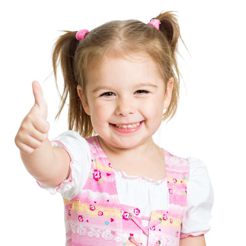 A small girl wearing a cute pink dress and showing a thumbs up