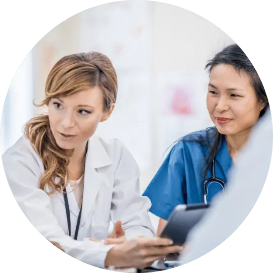 2 female doctors talking and listening to another woman giving Kensington Nanny a great nanny agency review.