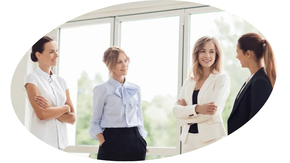 Group of women standing and talking. One is giving Kensington Nanny a great nanny agency review.
