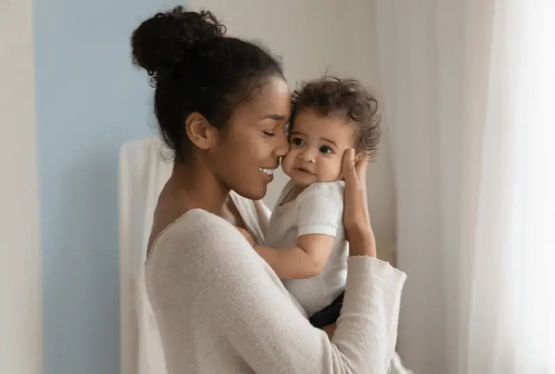 newborn care specialist is holding a newborn baby