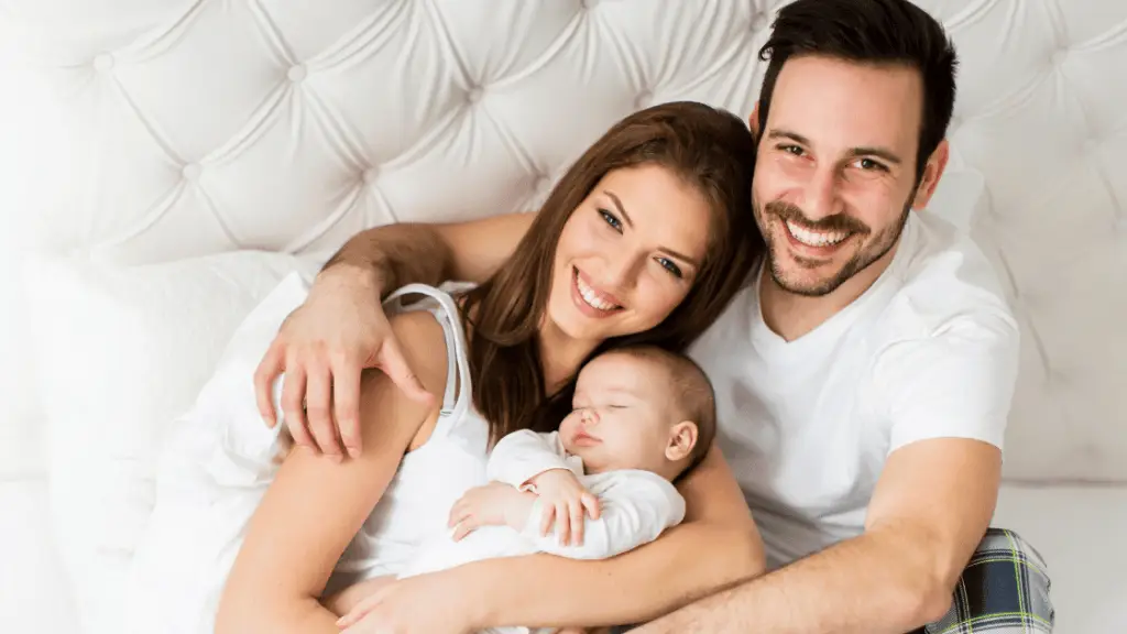 Sweet mother and father holding their baby, they are looking to hire a nanny in Miami, FL.